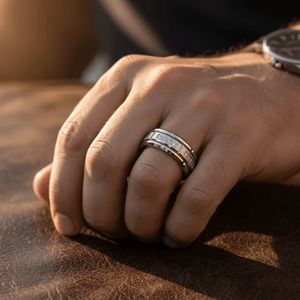 LUMORA — Lifestyle photo on hand — men's tungsten wedding ring.
