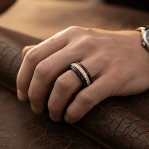 LUSTRE — Lifestyle photo on hand — men's tungsten wedding ring.