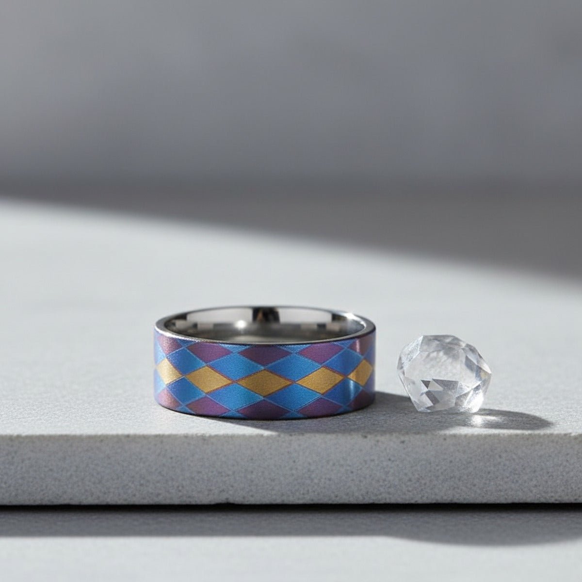 MAJESTIC flat titanium ring on slate stone with crystal, lifestyle scene