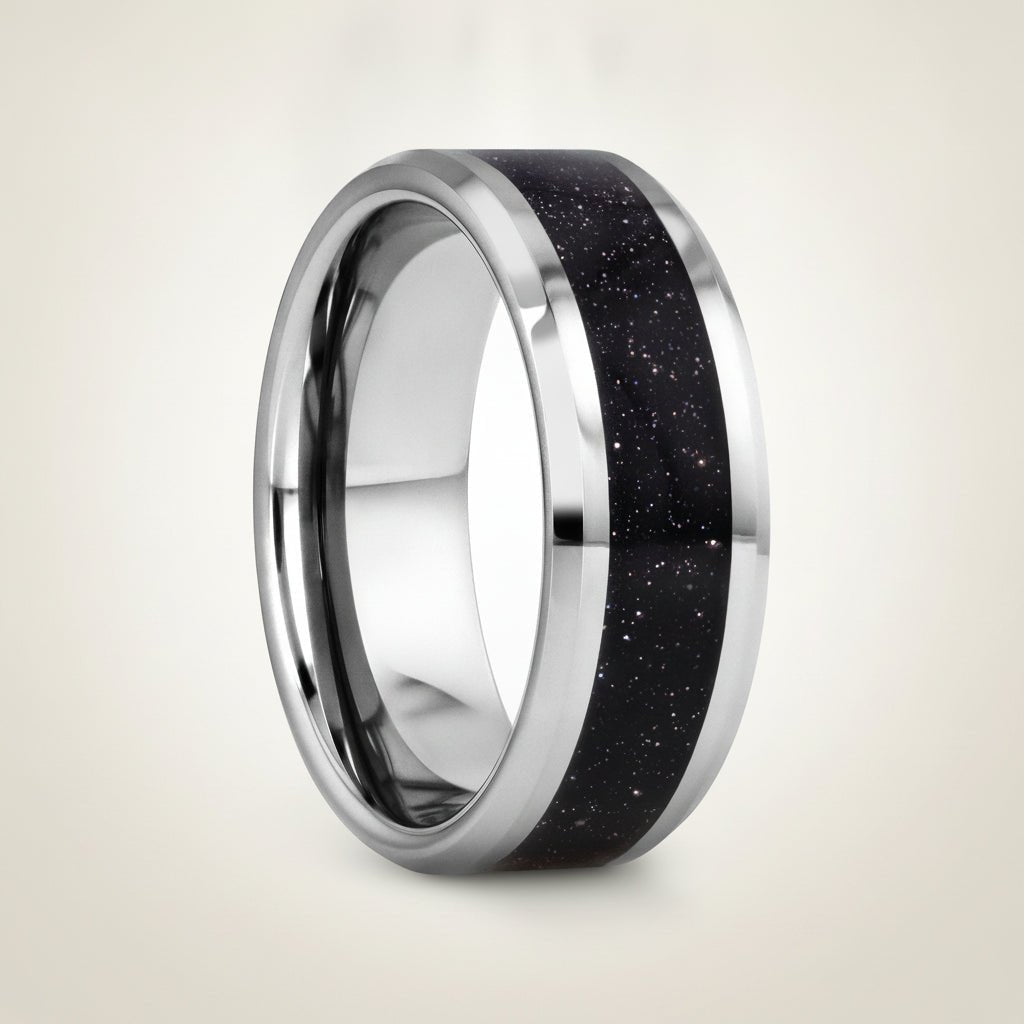 MAKI polished silver tungsten wedding band with sparkling purple goldstone inlay running around the band and polished beveled edges, studio hero shot
