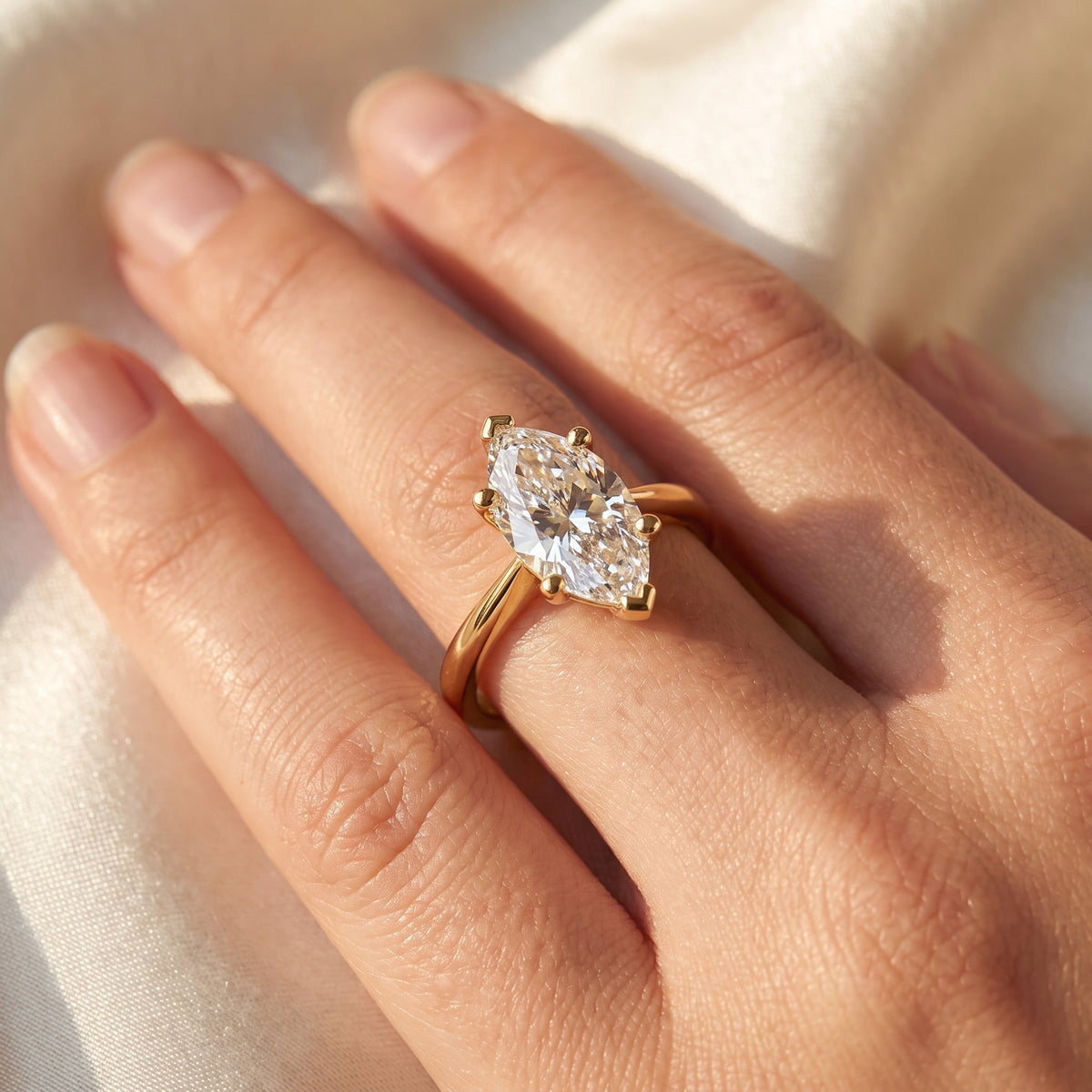 Marquise lab-grown diamond solitaire engagement ring, Yellow Gold, on-finger close-up