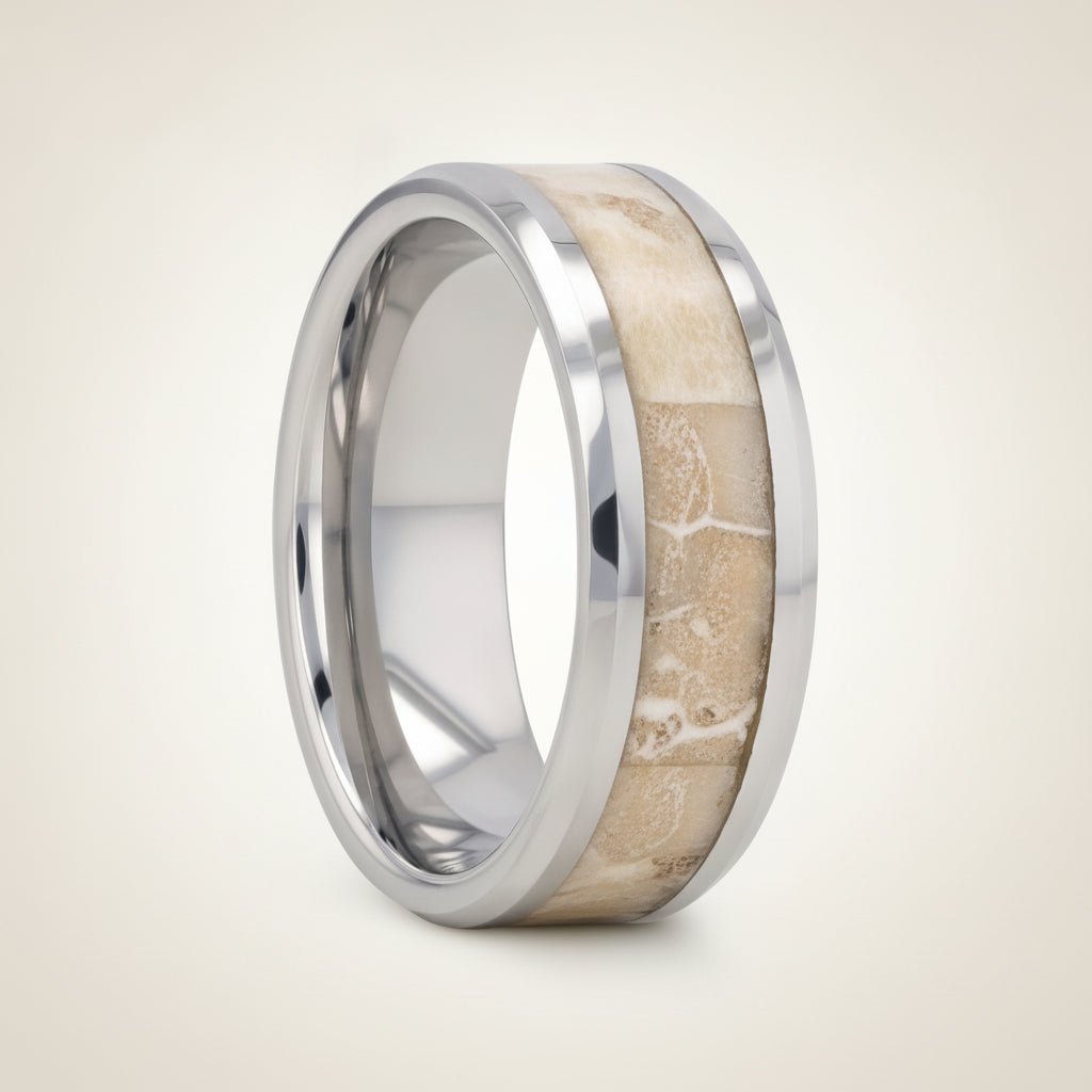 MESOZOIC silver tungsten ring with white dinosaur bone inlay running around the band and polished flat beveled edges, studio hero shot