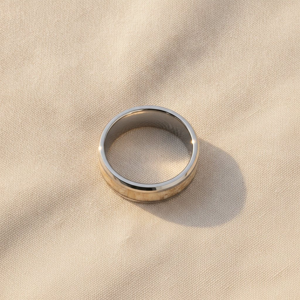 MESOZOIC silver tungsten ring with white dinosaur bone inlay running around the band and polished flat beveled edges macro detail overhead flat lay