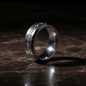 NESO — Luxury 3/4 angle on dark marble — men's tungsten wedding ring.