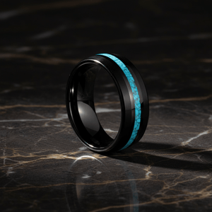 NETARTS — Luxury 3/4 angle on dark marble — men's tungsten wedding ring.