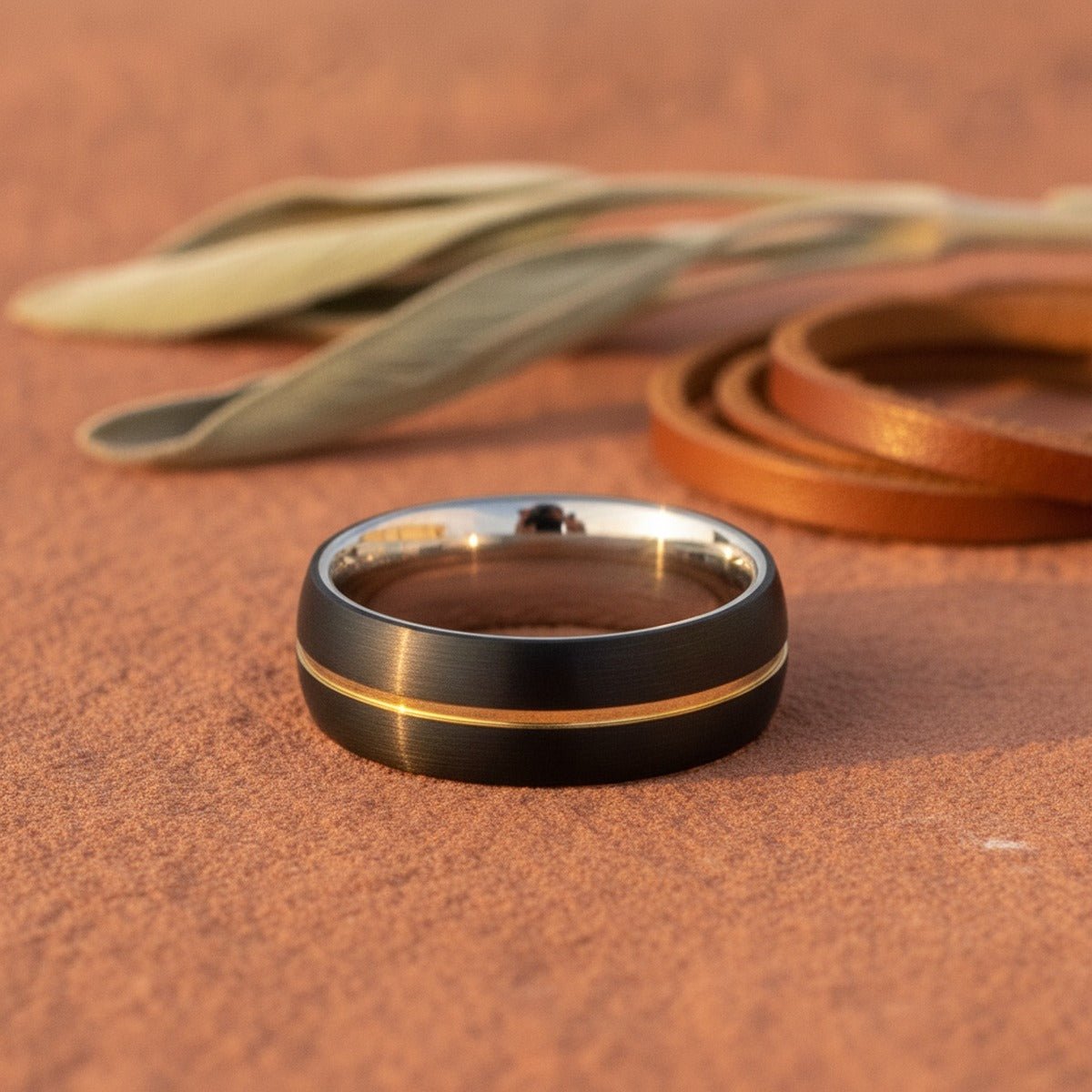 Aydins NEXUS | Silver Ring, Black Tungsten Ring, Gold Groove, Domed lifestyle scene, red canyon rock