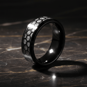 NIKNAM — Luxury 3/4 angle on dark marble — men's tungsten wedding ring.