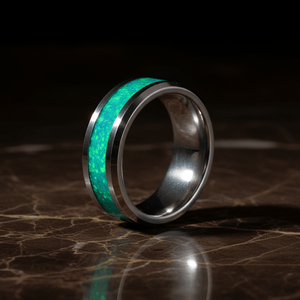 OCEARA — Luxury 3/4 angle on dark marble — men's tungsten wedding ring.
