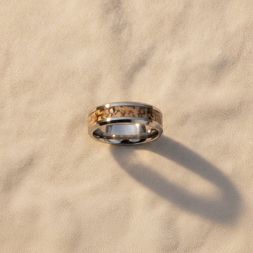 ORDOVICIAN silver tungsten carbide ring with brown dinosaur bone inlay running around the band and polished beveled edges macro detail overhead flat lay