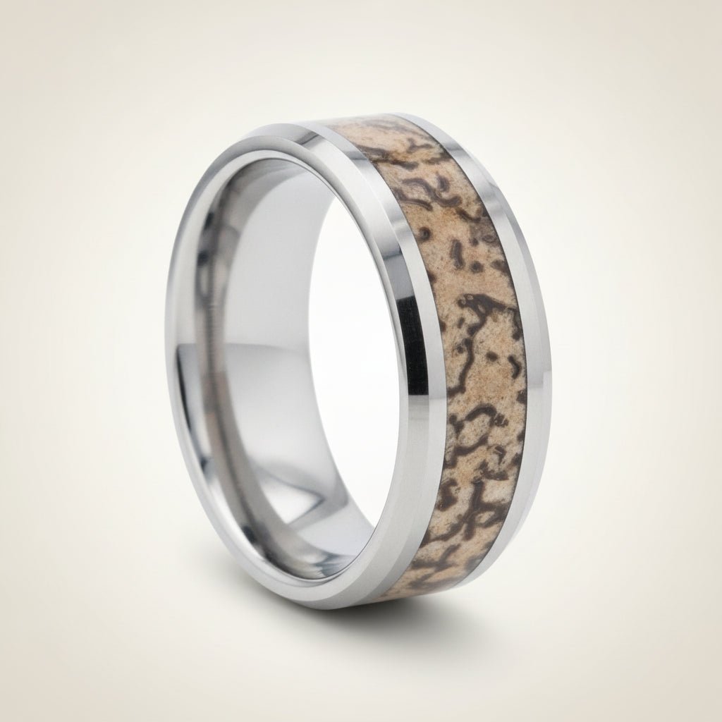 ORDOVICIAN silver tungsten carbide ring with brown dinosaur bone inlay running around the band and polished beveled edges, studio hero shot