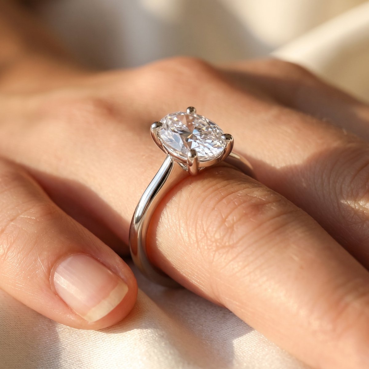 Oval lab-grown diamond solitaire engagement ring, White Gold, on-finger close-up