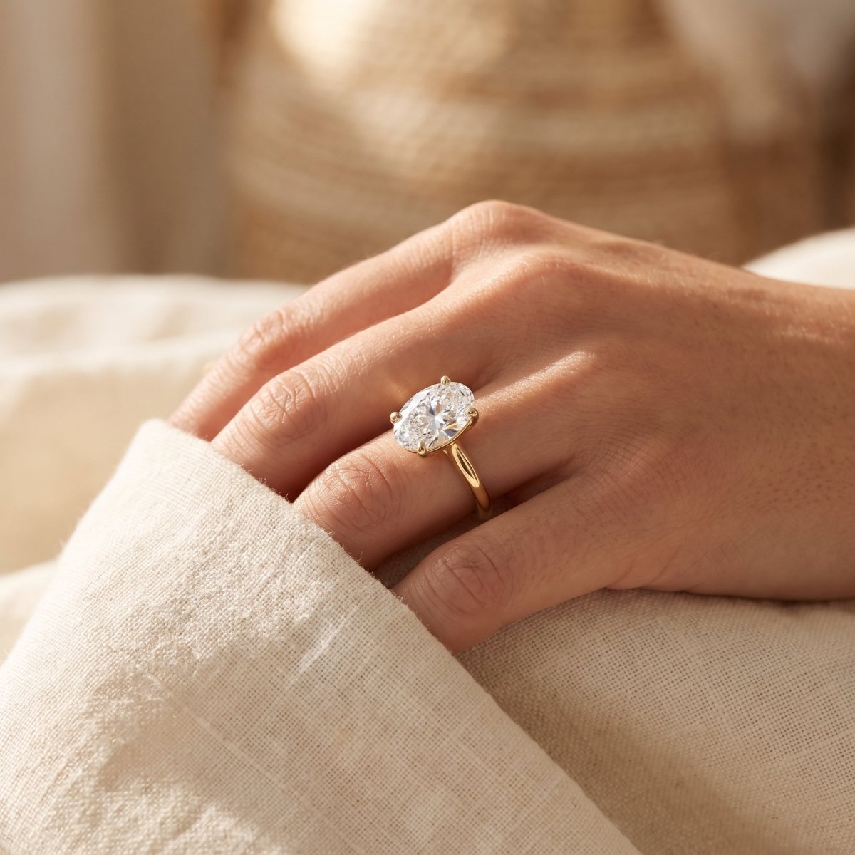 Oval lab-grown diamond solitaire engagement ring, Yellow Gold, lifestyle photograph