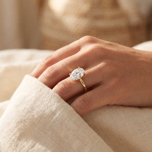 Oval lab-grown diamond solitaire engagement ring, Yellow Gold, lifestyle photograph