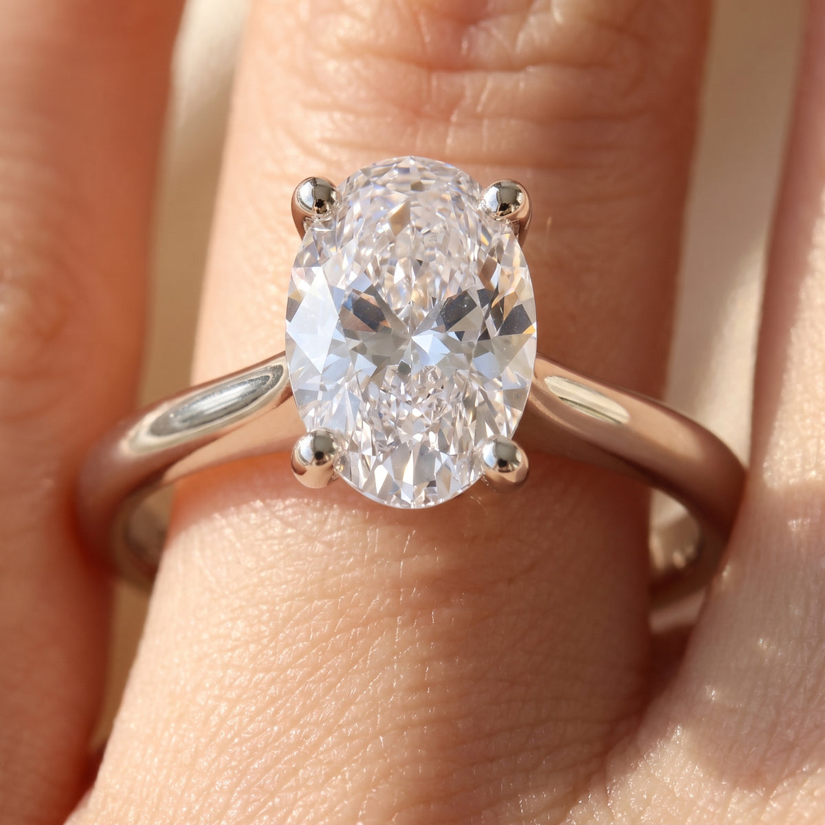 Oval lab-grown diamond solitaire engagement ring, 925 Sterling Silver, on-finger close-up