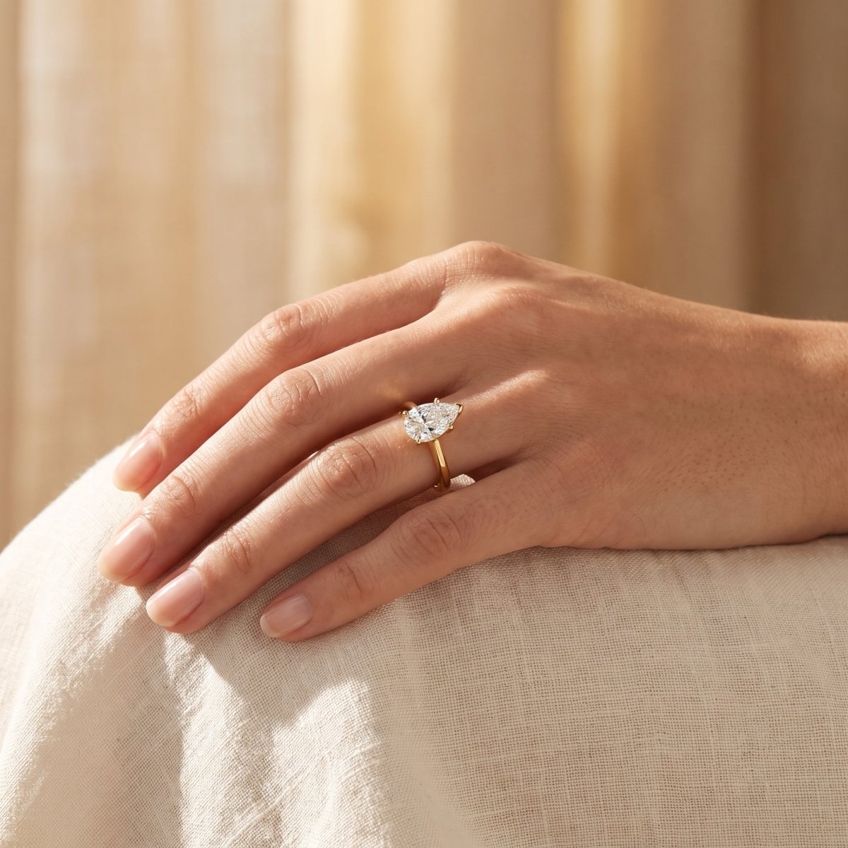 Pear lab-grown diamond solitaire engagement ring, Yellow Gold, lifestyle photograph