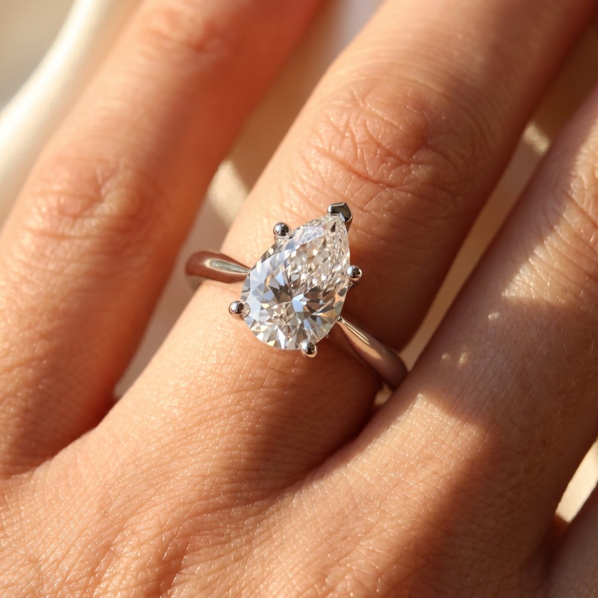 Pear lab-grown diamond solitaire engagement ring, 925 Sterling Silver, on-finger close-up