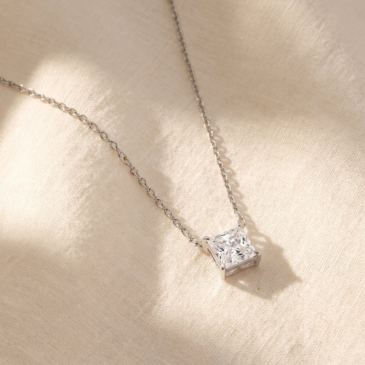 Princess Cut Diamond Pendant Necklace, silver, lab grown diamonds, on ivory linen