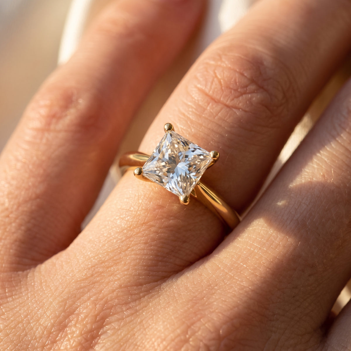 Princess lab-grown diamond solitaire engagement ring, Yellow Gold, on-finger close-up