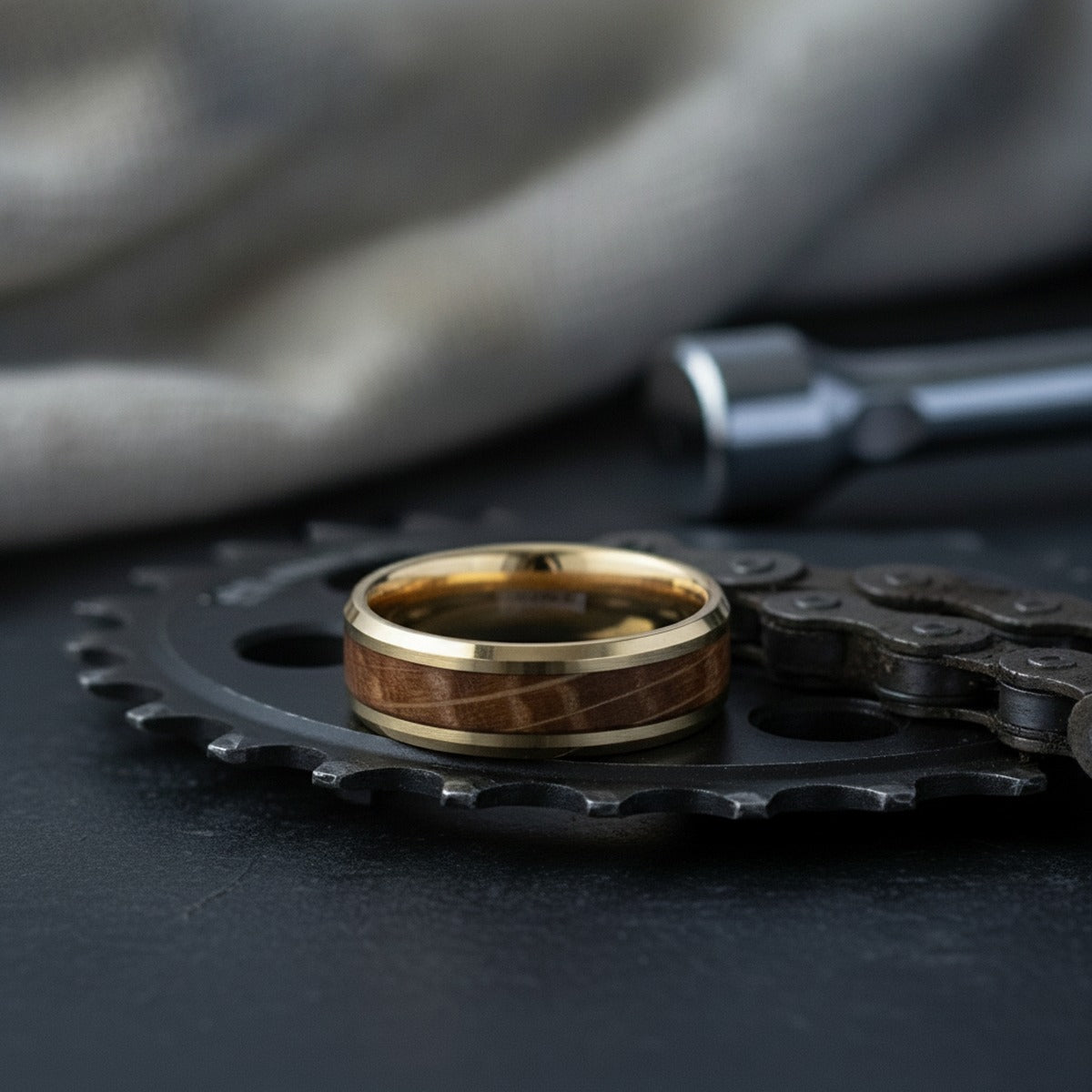 Aydins PROOF | Gold Tungsten Wedding Ring - Whiskey Barrel Wood Inlay, Polished Beveled Edges, 8mm lifestyle scene, cycling workshop