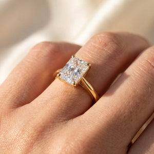 Radiant lab-grown diamond solitaire engagement ring, Yellow Gold, on-finger close-up
