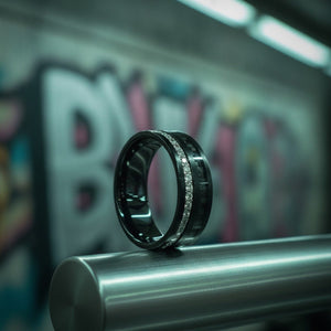 Aydins REACTOR | Black Tungsten Ring, Black Carbon Fiber and Eternity White CZ Inlay lifestyle scene, underground train