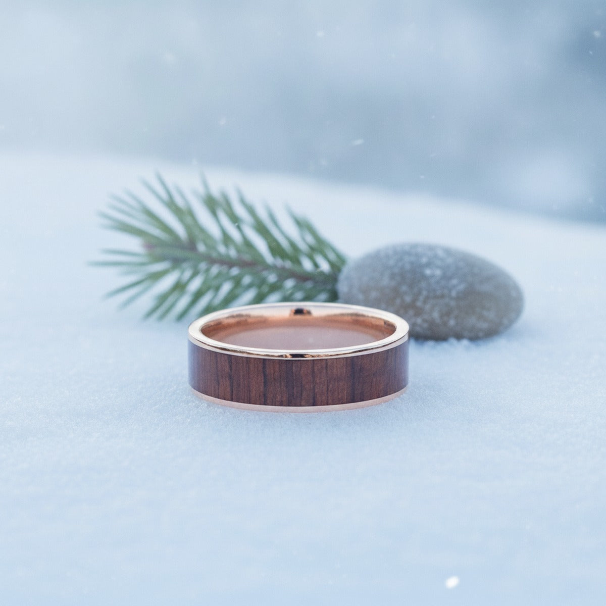 Aydins Polished 14k Rose Gold Men's Wedding Band with Padauk Wood Inlay - 8MM lifestyle scene, snowy pine
