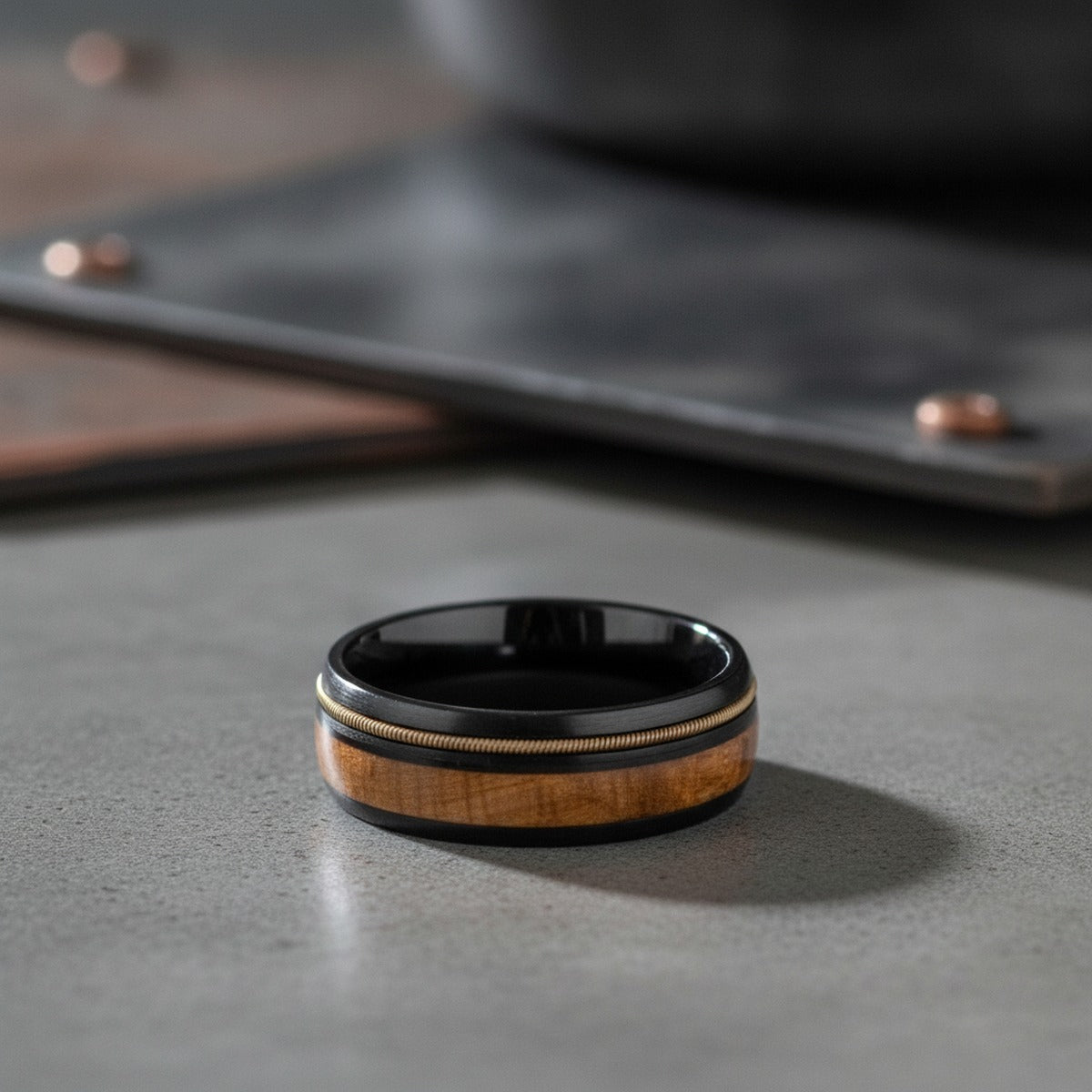Aydins RIFFSON | Tungsten Whiskey Barrel Wood Inlay Ring 8mm lifestyle scene, concrete industrial