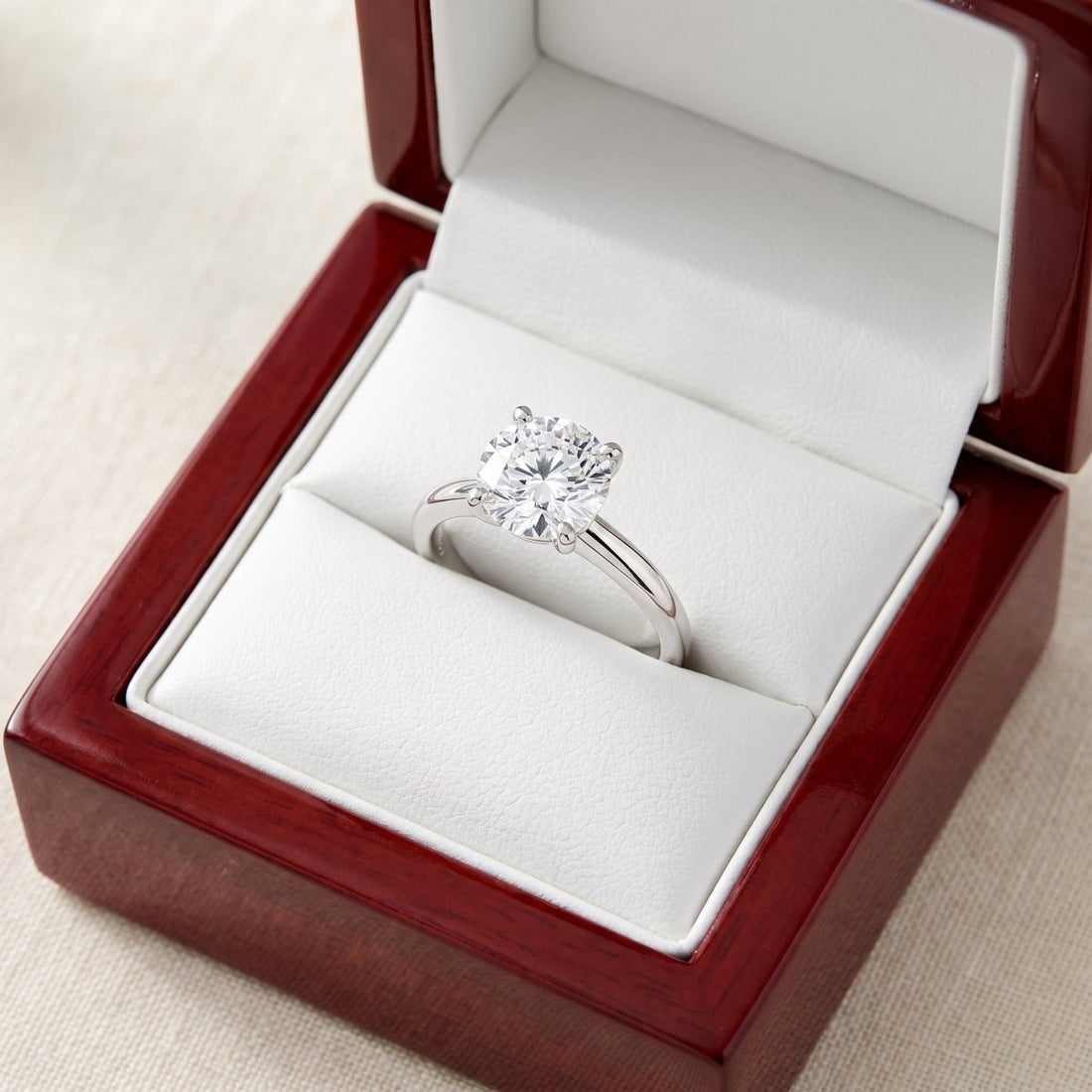 Round lab-grown diamond solitaire engagement ring, in White Gold, shown inside an open cherry-wood ring box