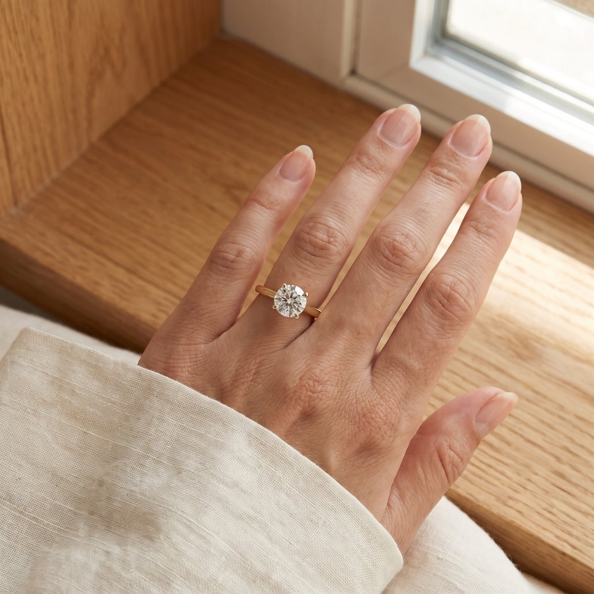 Round lab-grown diamond solitaire engagement ring, in Yellow Gold, lifestyle
