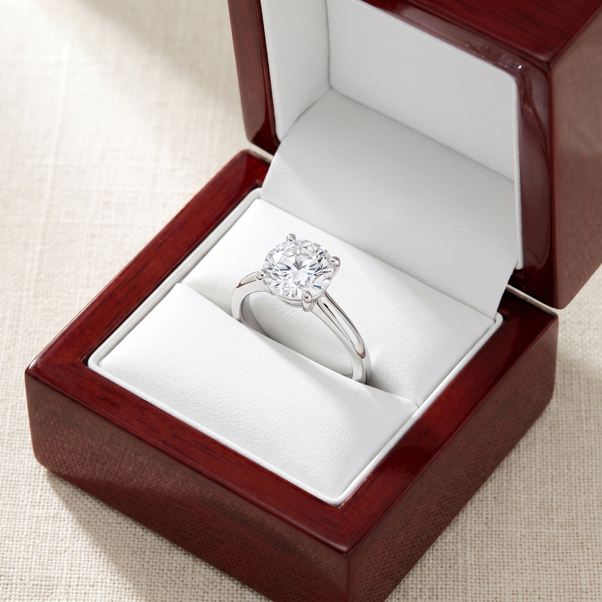 Round lab-grown diamond solitaire engagement ring, in 925 Sterling Silver, shown inside an open cherry-wood ring box