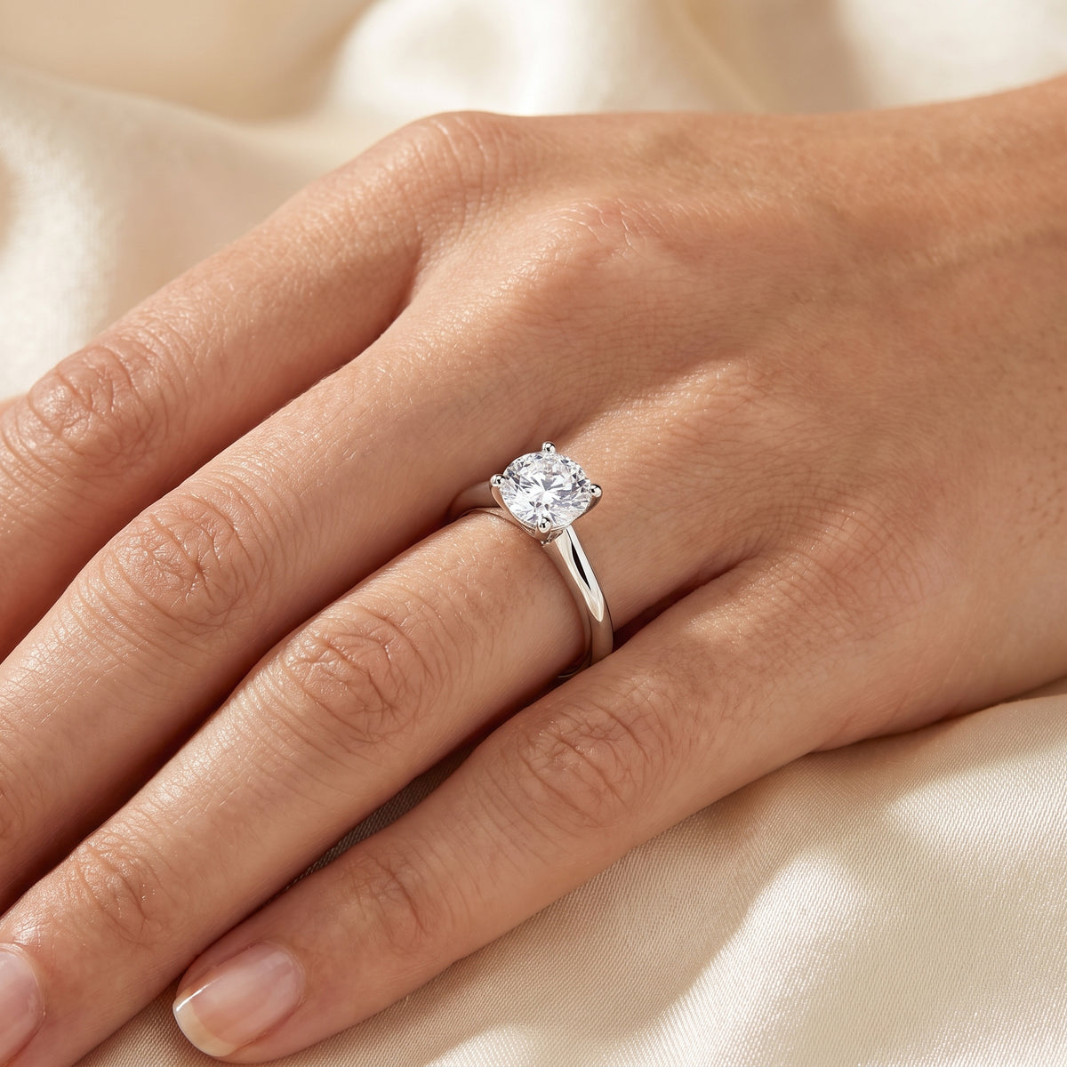 Round lab-grown diamond solitaire engagement ring, in 925 Sterling Silver, on-finger close-up