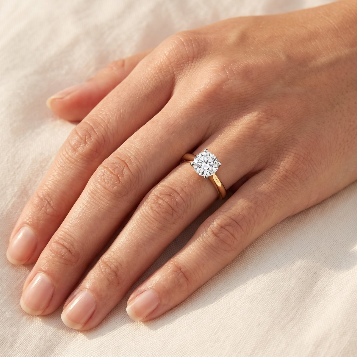 LOTTIE round lab-grown diamond ring in 10K two-tone gold, worn on the hand, approx. 1 ct center