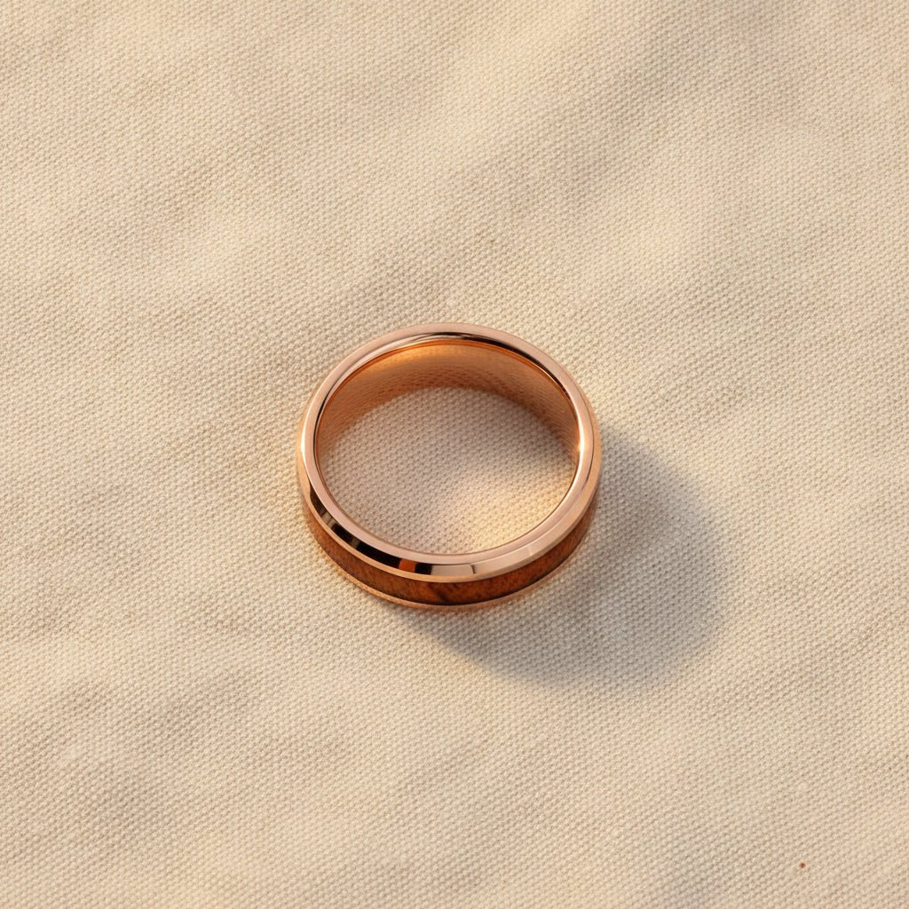 RUSTIC rose gold plated tungsten carbide wedding band with hawaiian koa wood inlay running around the band and shiny polished beveled edges macro detail overhead flat lay