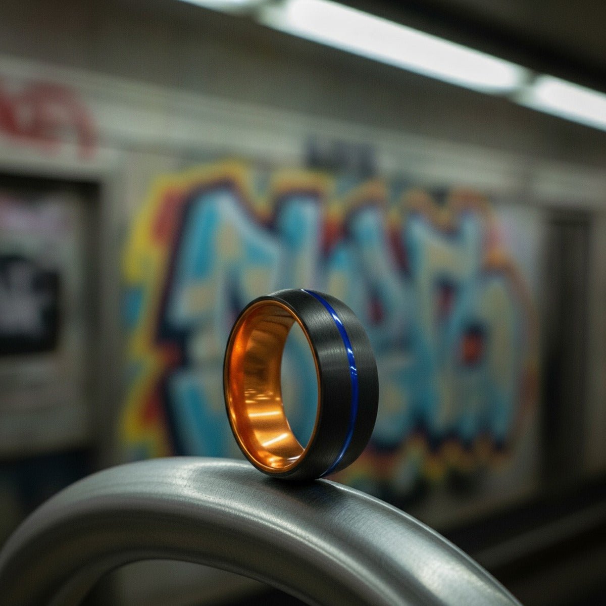 Aydins RUTILO | Orange Ring, Black Tungsten Ring, Blue Groove, Domed lifestyle scene, underground train