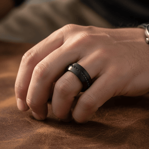 SANCHO — Lifestyle photo on hand — men's tungsten wedding ring.