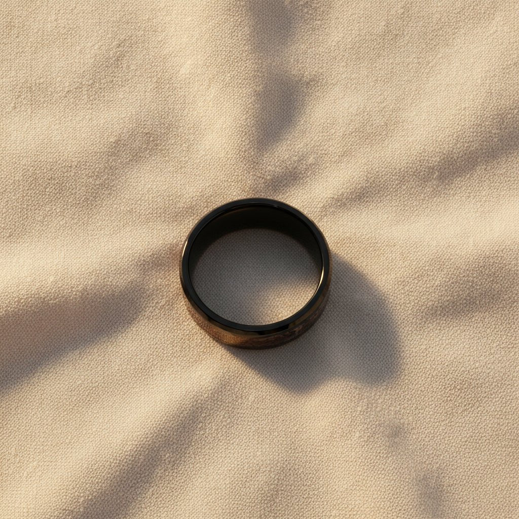 SILURIAN black ceramic ring with brown dinosaur bone inlay running around the band and polished beveled edges macro detail overhead flat lay