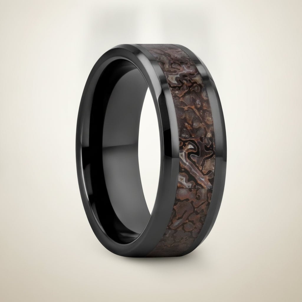 SILURIAN black ceramic ring with brown dinosaur bone inlay running around the band and polished beveled edges, studio hero shot