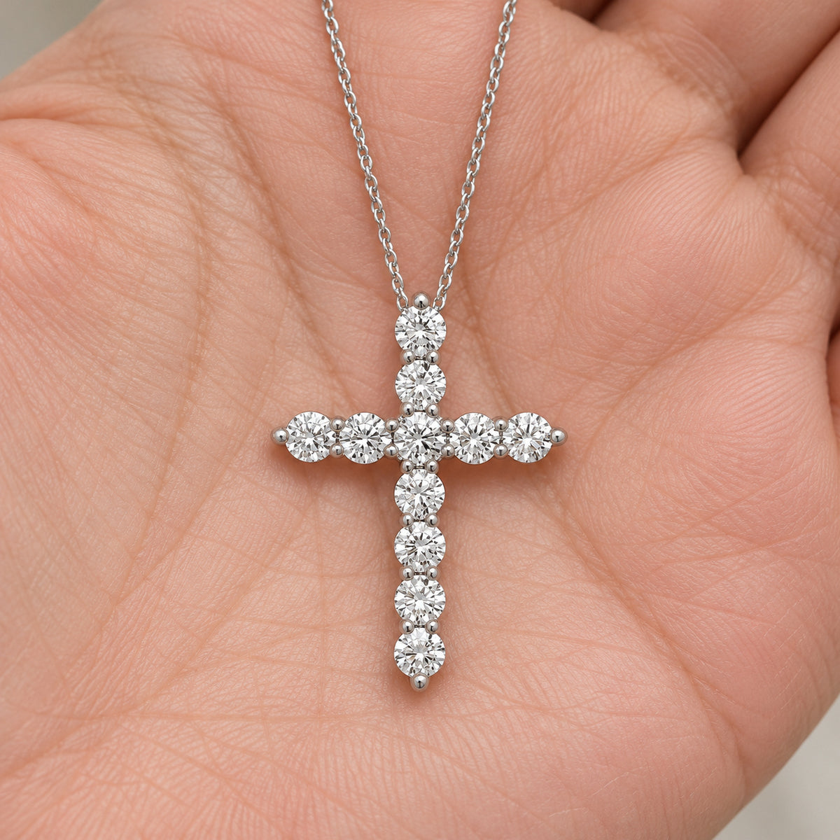 Statement Diamond Cross Necklace, silver, lab grown diamonds, resting on a hand
