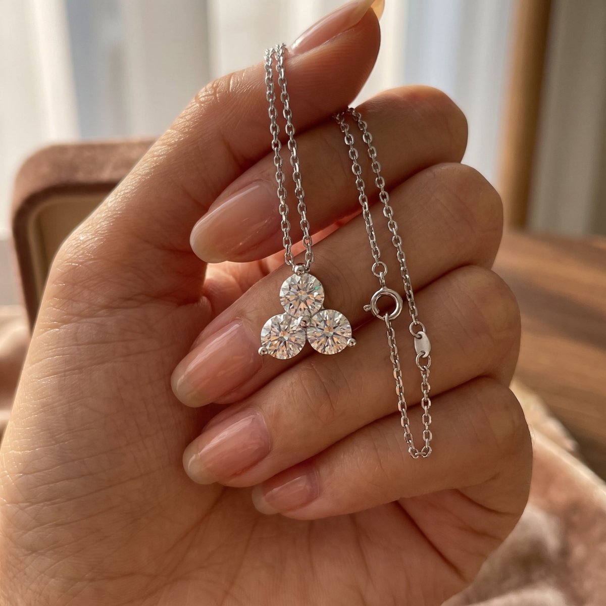 Three Stone Round Diamond Pendant With Chain 925 silver lab grown diamond pendant held in hand lifestyle close-up photo