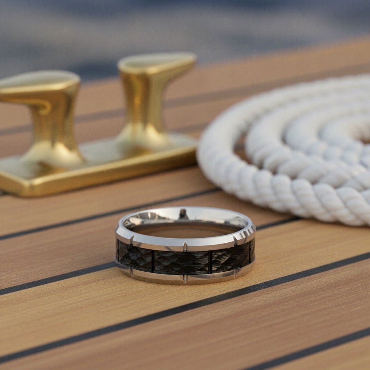 Aydins THYROS | Silver Tungsten Hammered Black Notched Wedding Ring 8mm lifestyle scene, yacht teak deck