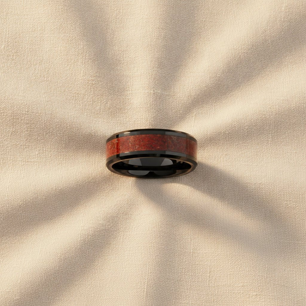 TRIASSIC black ceramic ring with red dinosaur bone inlay running around the band and polished beveled edges macro detail overhead flat lay