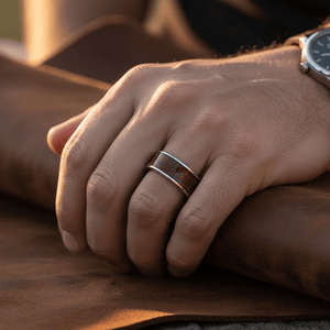 VANISH — Lifestyle photo on hand — men's tungsten wedding ring.