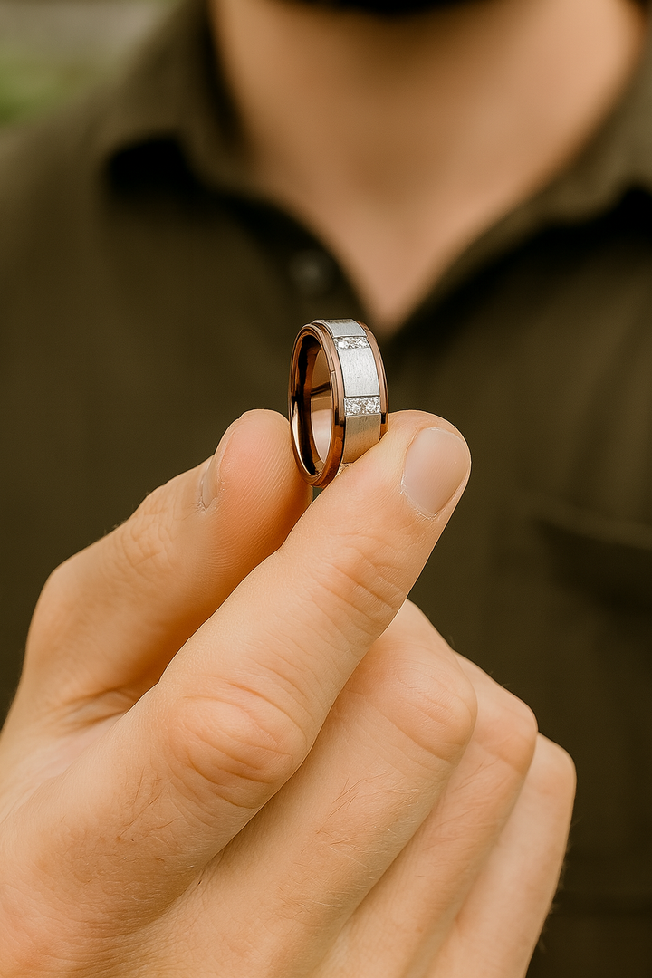 Comfort fit espresso tungsten wedding band for men holding the ring.