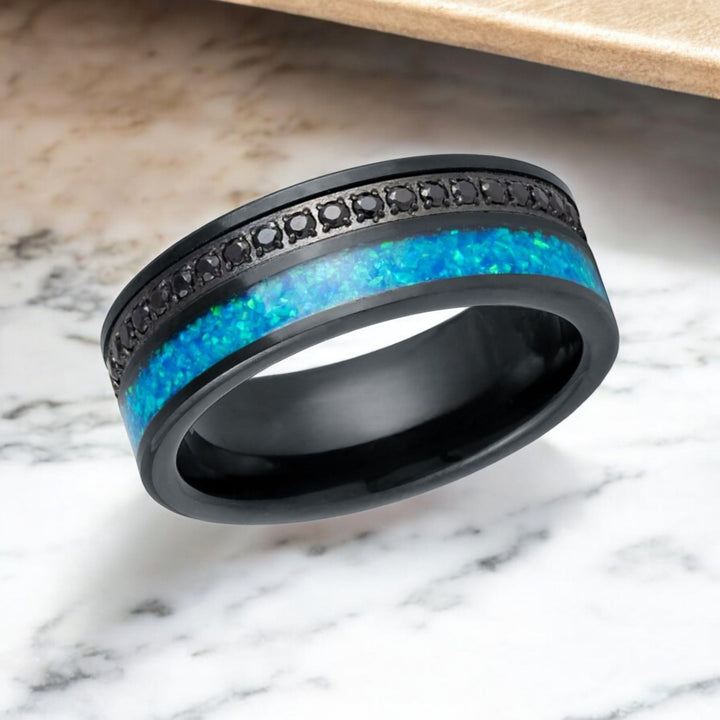 Close-up of AQUORION ring’s vibrant blue opal inlay and black CZ eternity stones.