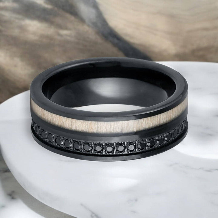 8mm black tungsten wedding band with bold black CZ eternity and rustic white wood design.