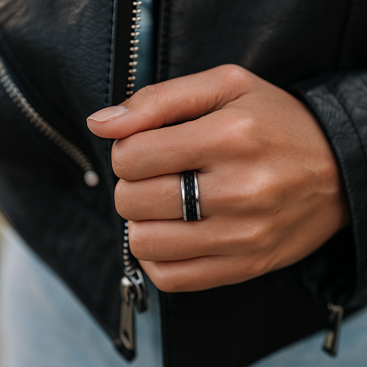 Close-up of black carbon fiber inlay and polished edge on hand