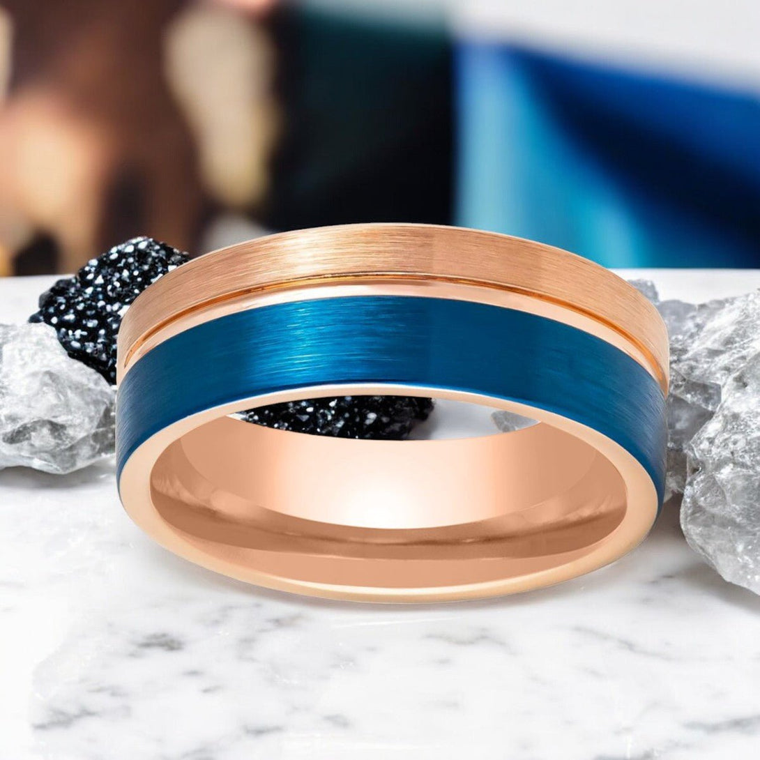 Angled view of ALNAIR Rose Gold Tungsten Wedding Band with Blue Brushed Finish