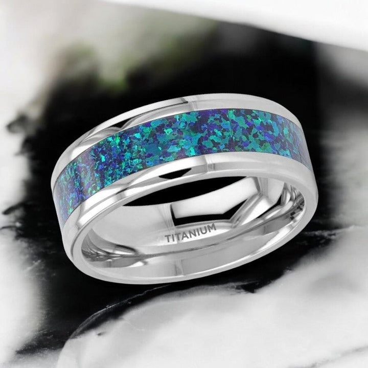 ANDROMEDA titanium wedding band featuring vibrant green-blue opal inlay and sleek beveled edges - Aydins Jewelry.