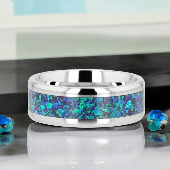 Elegant titanium wedding band with a vibrant green-blue opal inlay and polished edges - Aydins Jewelry.