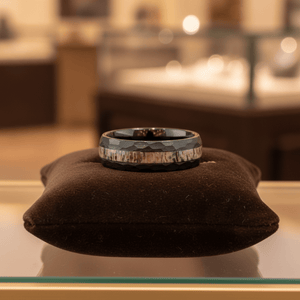 ANTLOR — Premium boutique display on velvet — men's tungsten wedding ring.